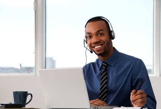 Customer Service agent in an office with laptop